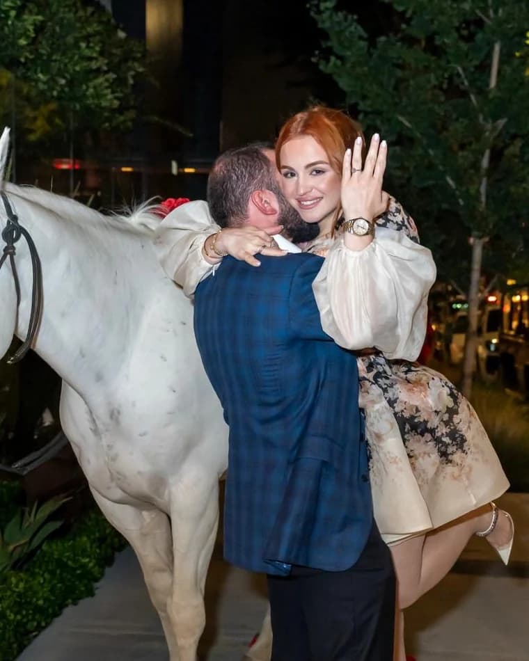 Lusine showing her engagement ring as Gevork embraces her